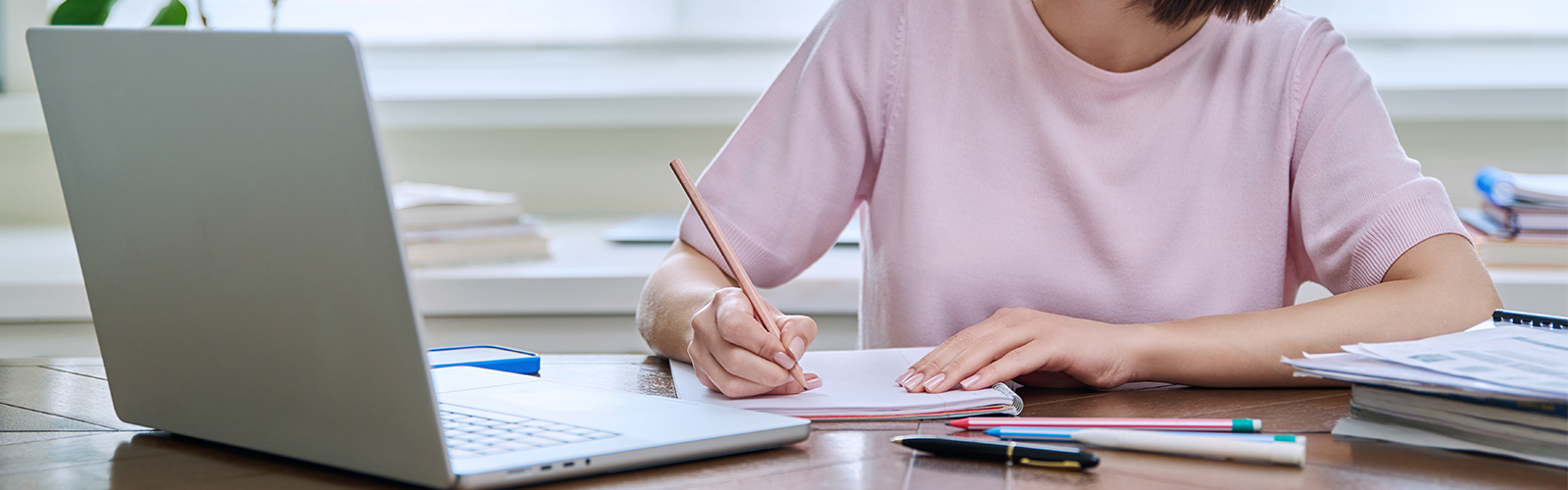 Young woman in headphones using computer laptop for studying.